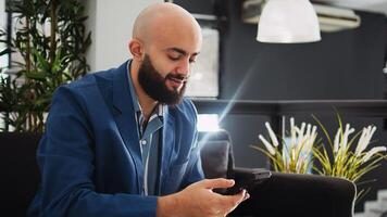 Manager examine sales statistics in startup business coworking space, looking at annual data reports on smartphone. Employee analyzing company information in office, successful entrepreneur. photo