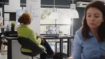 Team leader using internet remote conference on pc, talking to corporate employees about growth. Female entrepreneur chatting on teleconference call, videocall meeting in coworking space. photo