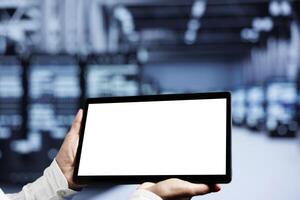 Close up shot of mock up tablet used by IT developer in supercomputer room delivering massive computing power, capable of processing and storing vast amounts of data and controlling network resources photo