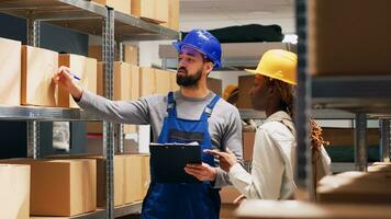 Multiethnic group of people working in storage room with cardboard boxes and stock products, shipping oders. Depot workers checking goods and merchandise in packages, delivery service. photo