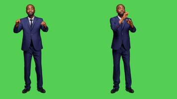 African american man having choir concert for opera event, conducting symphony standing over greenscreen backdrop. Male musician choirmaster playing formal music, modern conductor. photo