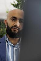Manager using web conference app on laptop to discuss project progress with team during virtual meeting. Arab start up entrepreneur listening to clients feedback about product in videocall photo