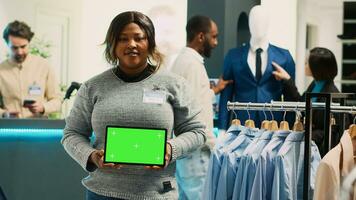 africano americano trabajador participación tableta con pantalla verde, publicidad comercial actividad con aislado mostrar. hembra asistente utilizando croma llave modelo con blanco copyspace pantalla. foto