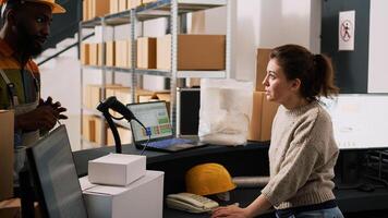 Worker carrying boxes to check barcodes and merchandise stock in warehouse, storage room inventory. Woman supervisor inspecting products on computer, quality control logistics. photo