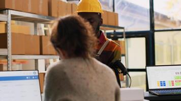 Delivery team discussing order shipment, preparing customers packages with products in storage room. Diverse warehouse workers doing inventory for goods and cargo on depot shelves. photo
