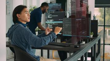 Trained developers helped by AR technology to visualize script in multiethnic office, writing code lines on computer using Java programming languages. Coworkers securing company data photo