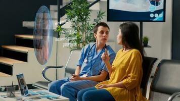 Doctor in modern clinic foyer using holographic projector, showing aged patient lungs close up scan, visualizing pulmonar exam results using AR technology and explaining curative remedies photo