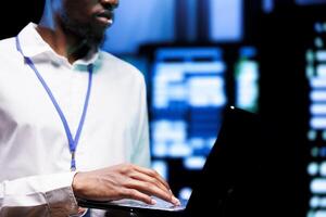 Engineer using laptop to optimize VPN servers with top security standards used to protect sensitive data. Technician working in enterprise data business providing online connections for users photo