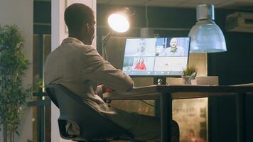 Manager working from home greeting employees in online videocall, discussing end of month project performance review during nightshift. Management executive talking with worker during teleconference photo