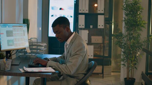 Stressed employees teamworking on company project tasks overnight before impending deadline. Experienced business colleagues comparing analytics datasets in office during nightshift photo