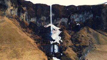 Drone shot of foss a sidu waterfall in iceland falling off cliff creating beautiful panoramic view, scenic route. Fantastic nordic cascade with stream flowing down of icelandic hills. Slow motion. photo