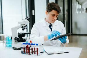 Modern medical research laboratory. female scientist working with micro pipettes analyzing biochemical samples, advanced science chemical laboratory photo