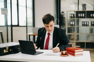 justice and law concept. Mature Male judge in a courtroom on table and Counselor working in modern office. photo
