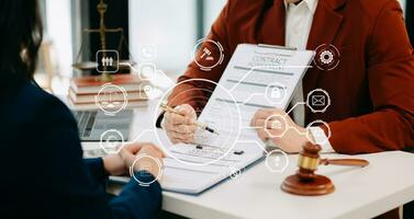 justice and law concept. asian woman lawyer working and judge in a courtroom the gavel, working with tablet and laptop and digital tablet computer on white table with VR icon photo