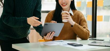 Businessman and team analyzing financial statement Finance task. with smart phone and laptop and  tablet. Wealth management concept photo