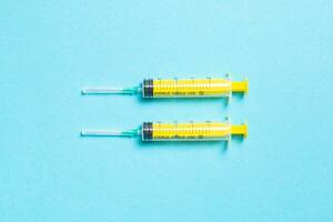 Top view of medical syringes on colorful background. Health care concept with copy space photo