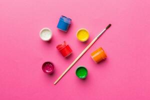 art palette with paint and brushes, close up. Top view with empty space. workplace for creativity. home teaching concept drawing photo