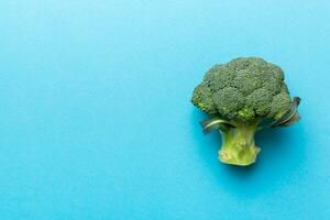 Top view fresh green broccoli vegetable on Colored background. Broccoli cabbage head Healthy or vegetarian food concept. Flat lay. Copy space photo