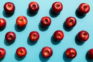 Many red apples on colored background, top view. Autumn pattern with fresh apple above view photo