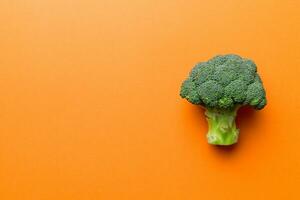 Top view fresh green broccoli vegetable on Colored background. Broccoli cabbage head Healthy or vegetarian food concept. Flat lay. Copy space photo