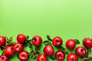 Many red apples on colored background, top view. Autumn pattern with fresh apple above view with copy space for design or text photo