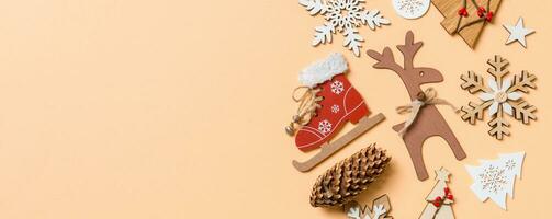 Top view of New Year toys and decorations on orange background. Christmas time concept Banner with empty space for your design photo