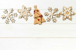 Top view of Christmas decorations and toys on wooden background. New Year holiday concept with empty space for your design photo