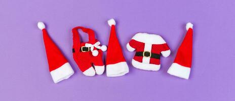 Top view of colorful holiday background made of Banner Santa hats and clothes. Merry Christmas concept with copy space photo