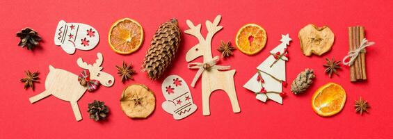 Top view Banner of red background decorated with festive toys and Christmas symbols reindeers and New Year trees. Holiday concept with copy space photo