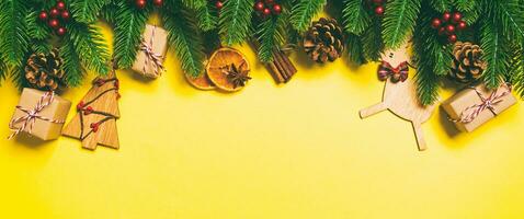 Top view of Christmas decorations on yellow background. Banner New Year holiday concept with copy space photo