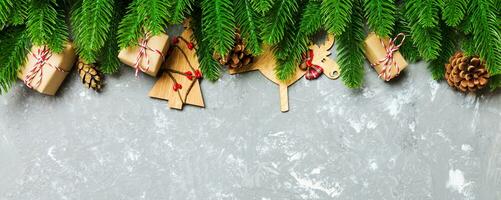 Top view Banner of Christmas background made of fir tree and decorations on cement background. New year holiday concept with copy space photo