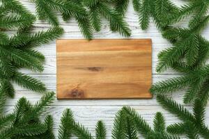 Festive table decoration with New Year branches and an empty plate. Top view with space for text. Christmas time photo