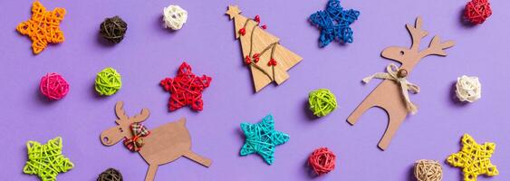 Banner New Year decorations on purple background. Festive stars and balls. Merry Christmas concept photo