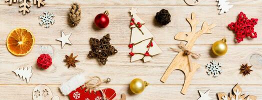 Banner top view of Christmas toys on wooden background. New Year ornament. Holiday concept photo