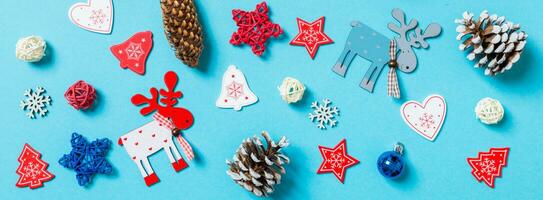Top view of New Year toys and decorations on blue background. Banner Christmas time concept photo