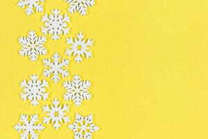 Top view of white snowflakes on colorful background. Winter weather concept with copy space. Merry Christmas concept photo