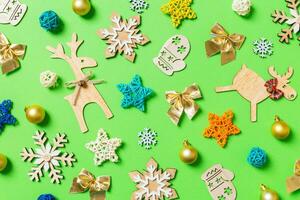 Top view of green background with New Year toys and decorations. Christmas time concept photo