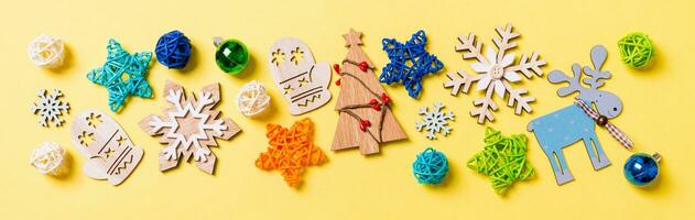 Top view Banner of yellow background with New Year toys and decorations. Christmas time concept with copy space photo