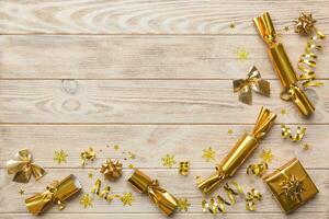 Christmas crackers with shiny confetti on color background, top view, copy space photo