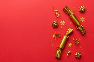 Christmas crackers with shiny confetti on color background, top view, copy space photo