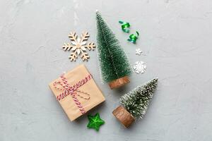 Flat lay composition with christmas trees on color background. Top view with copy space photo