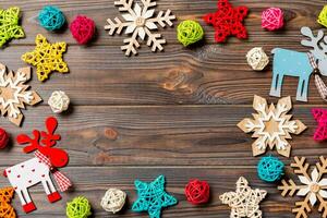 Top view of Christmas decorations and toys on wooden background. Copy space. Empty place for your design. New Year concept photo