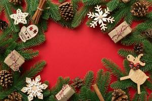 Christmas decorations and fir tree branch and gift boxon dark table. Top view frame with copy space photo