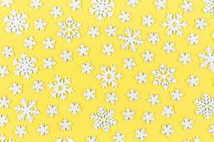 Top view of white snowflakes on colorful background. Winter weather concept with copy space. Merry Christmas concept photo