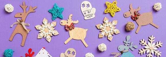 Banner Festive decorations and toys on purple background. Merry Christmas concept photo