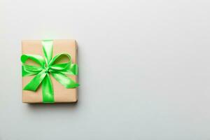 Holiday present box over colored background, top view. Copy space for design photo
