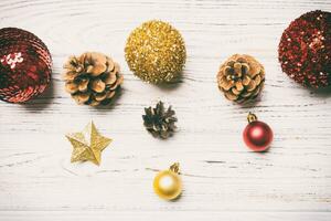 Top view of festive winter composition on wooden background with empty space for your design. Christmas baubles and decorations. New Year concept photo
