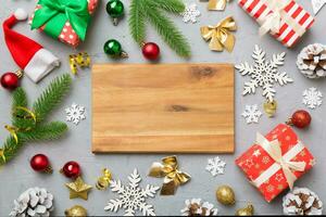 Festive table decoration with New Year branches and dekor an empty plate. Top view with space for text. Christmas time photo