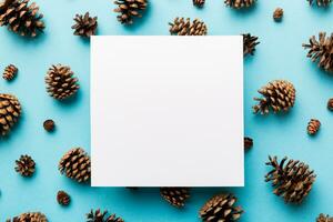 Creative frame made of Christmas pine cones with square Paper blank. Xmas and New Year theme. Flat lay, top view copy space photo