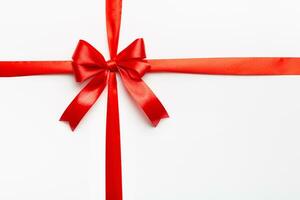 Top view of Red ribbon rolled and red bow isolated on colored background. Flat lay with copy space photo